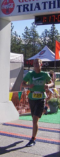 Invermere resident Carson Tomalty crosses the finish line of the Wasa Triathlon