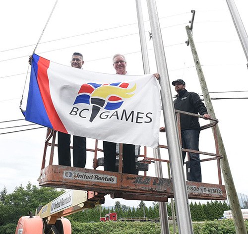 Michael Lopez from the Quality Hotel (left) and Steve Carlton from the BC Games display the event's official flag during its unveiling at the hotel on Thursday.