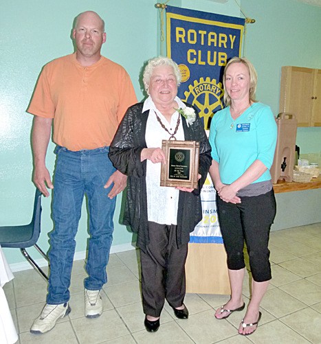 Julie McIntosh stands with the Citizen of the Year award