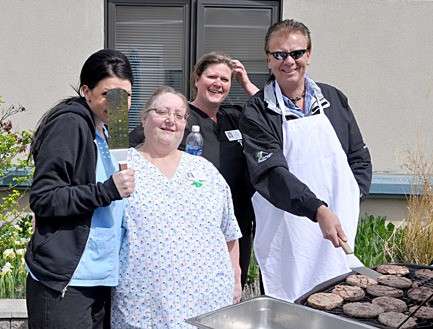 College of the Rockies (COTR) Health Care students wait for burgers prepared  by  COTR Invermere campus manager Doug Clovechok at a meet and greet event at Columbia House in Invermere.