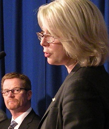 Health Minister Terry Lake listens as Environment Minister Mary Polak announces changes to carbon neutral government program Tuesday.