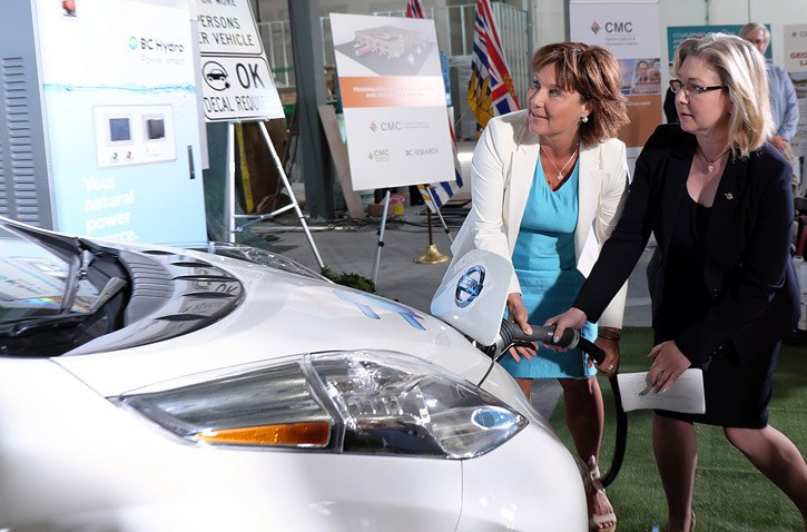 Premier Christy Clark and Environment Minister Mary Polak plug in an electric car at an announcement of the government's latest climate change plan in Richmond Aug. 19.