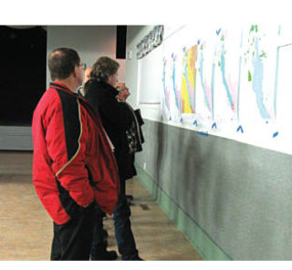 Windermere residents study the maps demonstrating some of the proposed changes in and around Lake Windermere. Madison Samuel-Barclay/Echo Photo