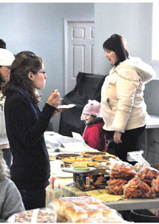 Residents and visitors gathered at the community hall in Windermere for a winter farmers' market.  Darryl Crane/echo photo