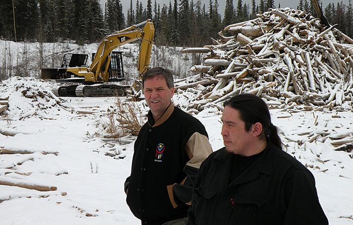 Former aboriginal relations Minister George Abbott and Tsay Keh Dene Chief Dennis Izony walk along the shore of Williston Lake in February 2010