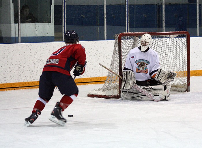 Rockies goalie Stewart Pratt protects the net against a Golden shooter during the Rockies 4-2 loss Saturday night.