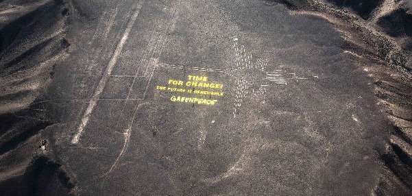 Greenpeace employees dragged big yellow letters across the fragile desert crust of the Nazca Lines