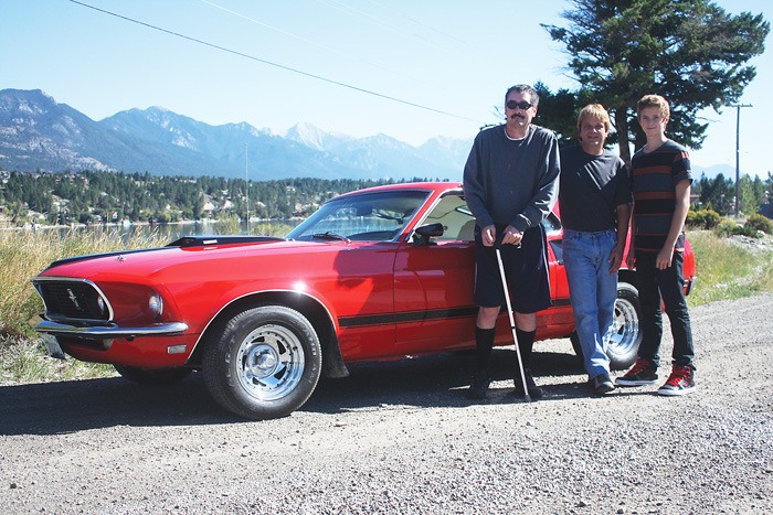 Pictured with the 1969 Ford Mustang Mach 1 are past owner Lawrence Godlien (left)