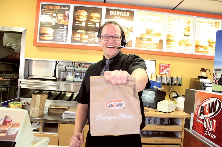 Selling a teen burger combo brings a smile to the face of Invermere A&W assistant manager Jarrett Nixon