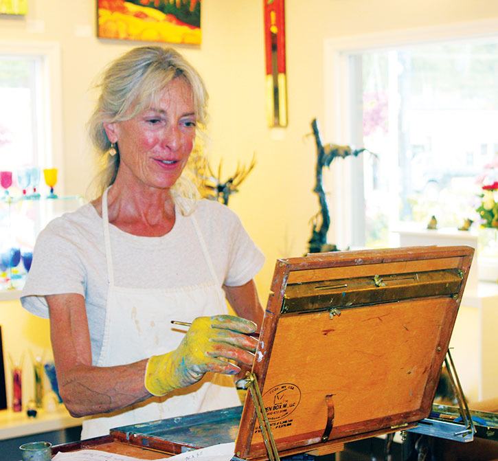 artist Denise Lemaster painted up a storm at The Artym Gallery for curious onlookers during Art Walk