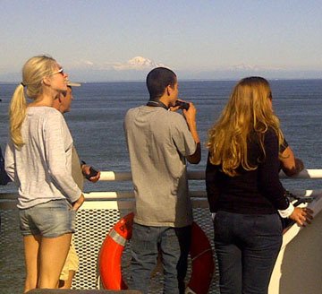 Passengers watch killer whales on BC Ferries' Tsawwassen-Swartz Bay run. Sunny days through July have given a boost to tourism.