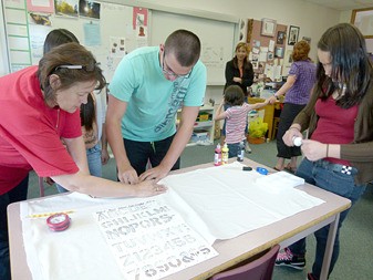 Volunteers and students begin work on their aboriginal banner