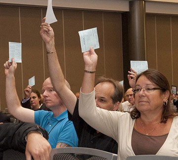 Local government representatives vote on a long list of resolutions at their convention in Vancouver Thursday.