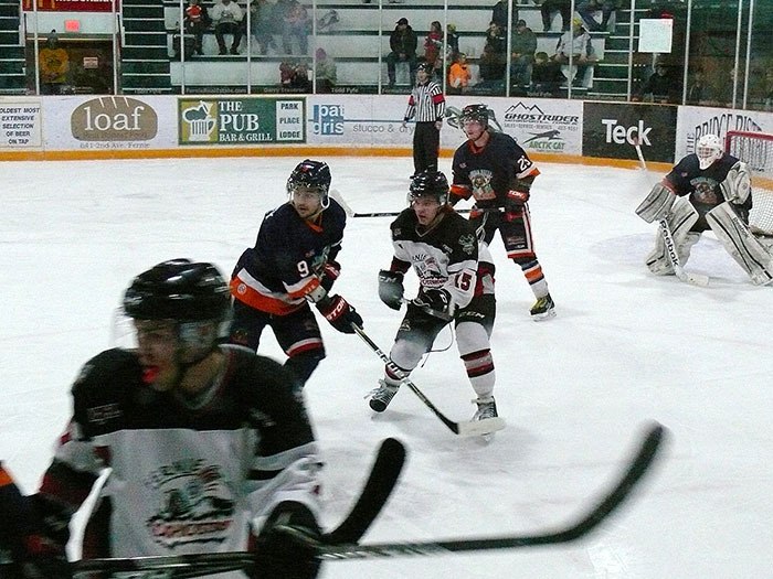 Columbia Valley Rockies players battle for the puck against the Fernie Ghostriders during game 2 of their first-round KIJHL playoff series on Sunday