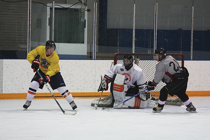 Rockies defenceman Brendan Sage (left) trains with DTSS students at the Hockey Canada Skills Academy at Eddie Mountain Memorial Arena on Monday