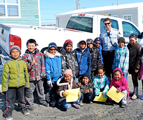 Constable Tim Harper stands with local children from Whale Cove