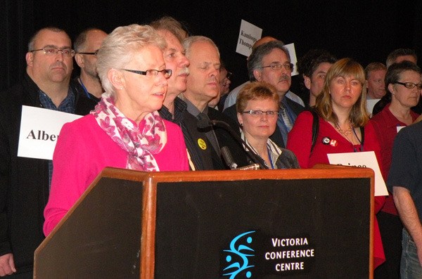 BCTF president Susan Lambert is flanked by teacher local representatives from all 60 school districts at the union's convention in Victoria Monday.
