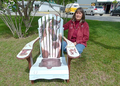 Columbia Valley artist Sherry Mallach with her painted Muskoka chair. The chair is up for silent auction as part of 2011's Tour of the Arts Artsy Deck Chair Auction and is currently available to view at Essentials in Invermere.