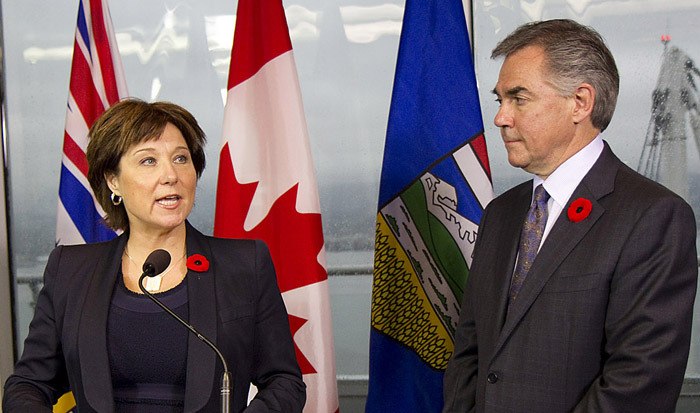 Premier Christy Clark and Alberta Premier Jim Prentice speak to reporters in Vancouver Monday.