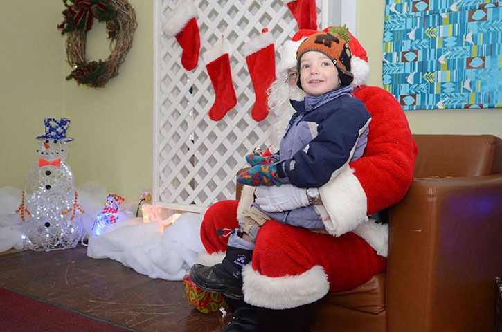Little tyke Jake  Hildes shares a special moment with jolly St. Nick in Santa’s Cabin at Fairmont Hot Springs Resort on Saturday
