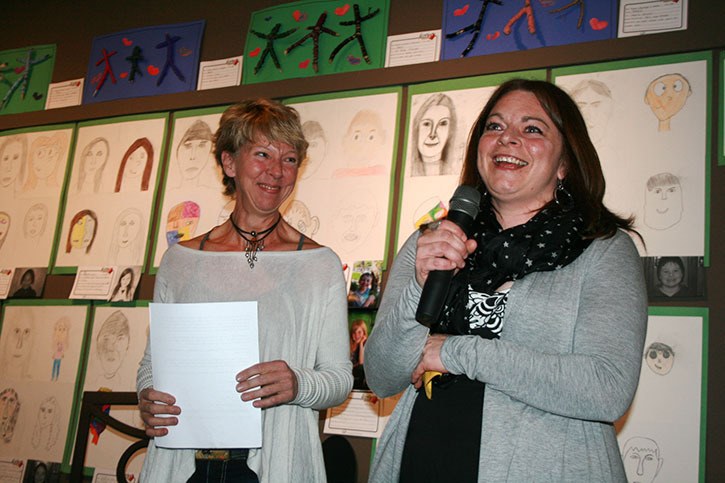 Columbia Valley Arts Council executive director Jami Scheffer (left) and Art From The Heart curator Natalie Ruby exude pride and excitement for the children’s art decorating the walls of Pynelogs during the artist opening event on Saturday