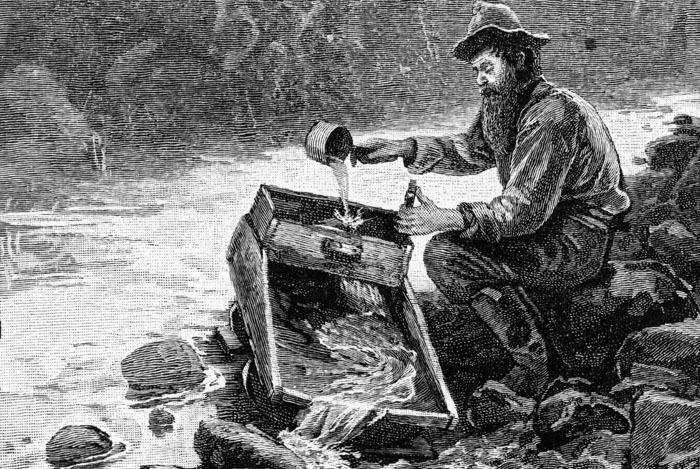 A 19th Century placer miner uses a rocker box to search for gold. Placer mining has become mechanized and remains an active industry in B.C.