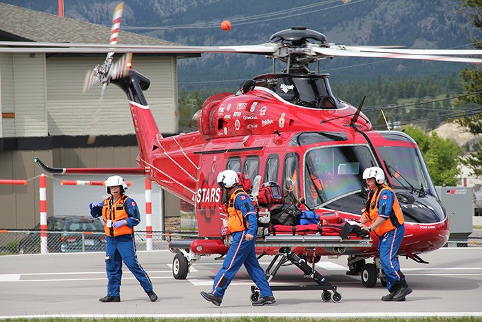 STARS members on the helipad at the Invermere & District Hospital prepare to transport the one-year-old girl rescued from Dutch Creek on Wednesday