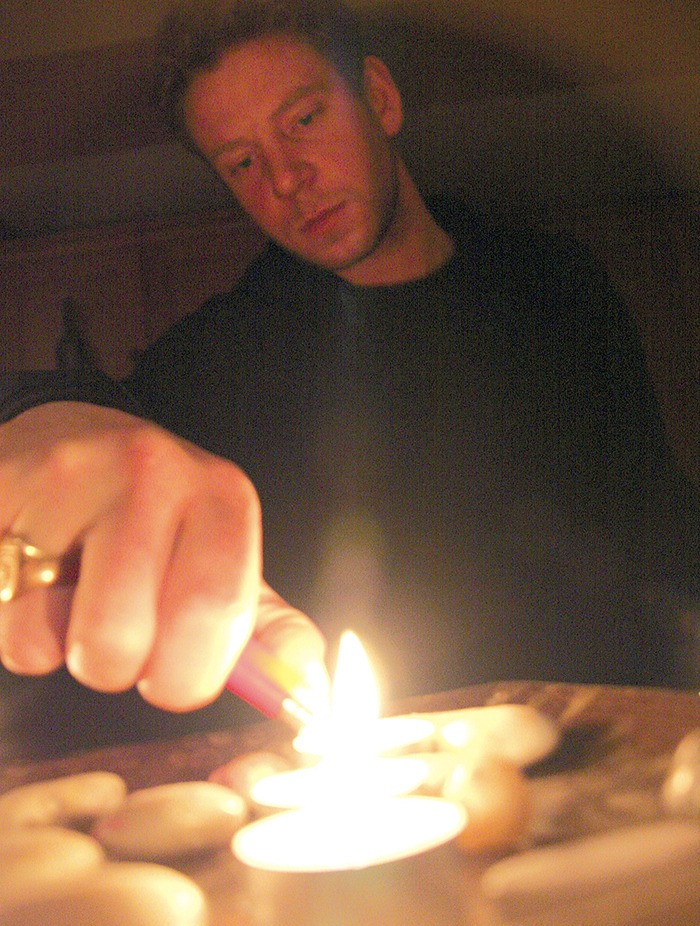 2010 — Radium Hot Springs resident Miles Spencer Norrington flicks off the switch for Earth Hour on March 29.