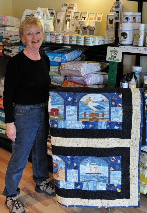 Sylvia Schulz of ICAN(Invermere Companion Animal Network) poses with a quilt valued at $300. The quilt is part of a silent auction that ends Wednesday May 14