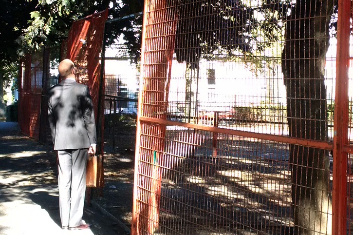 A passer-by looks at what's left after the evacuation of a 10-month tent camp in downtown Victoria.