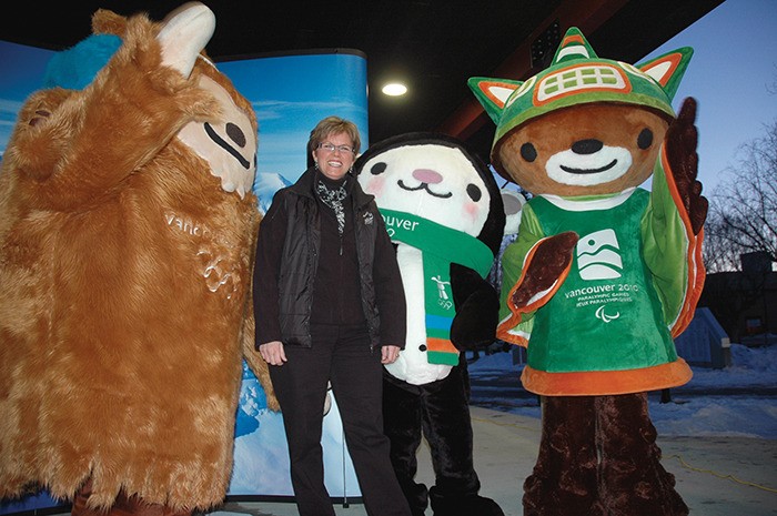 Echo file photo 2009 - Village of Radium Hot Springs Mayor Dee Conklin strikes a pose with two of the four 2010 Olympic Winter Games mascots