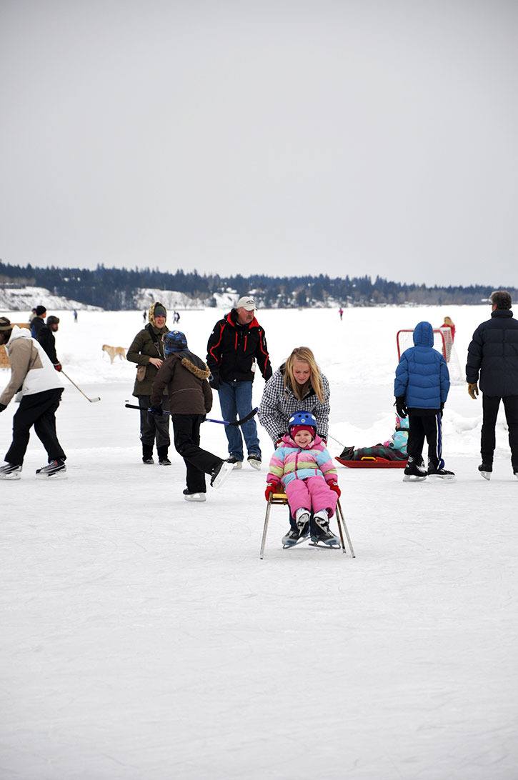 2011 — A young skater decked out in a stylish snowsuit gets a helping hand while enjoying the ice on Lake Windermere