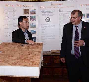 Forests Minister Steve Thomson (right) is shown insulated structural panels made with B.C. oriented strandboard and lumber