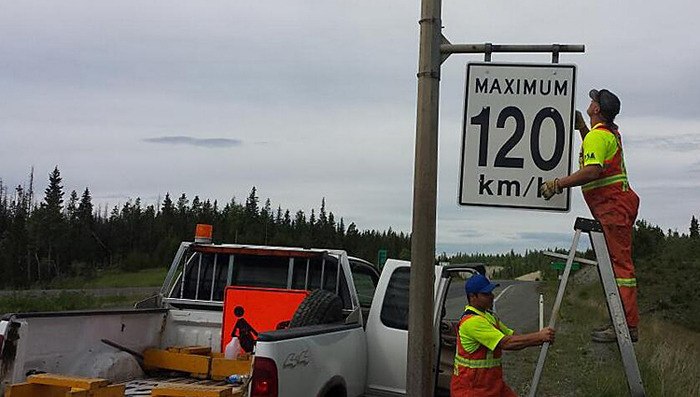 Sign crew posts new speed limit Wednesday on the Okanagan Connector