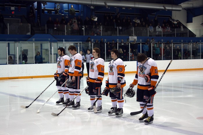 The Rockies stand proudly during the singing of the national anthem prior to their game against Fernie.