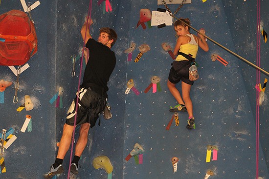 Two rock climbers are seen taking advantage of the rock climbing drop-in program offered at J. A. Laird on Friday