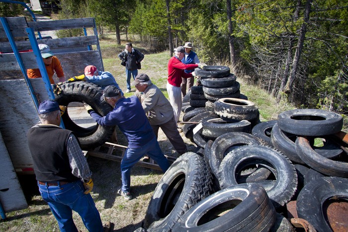 Wildsight members and other volunteers wrestle a truck tire into a horse trailer full of tires destined for the Windermere landfill during the weekend's Valley Pride cleanup day.