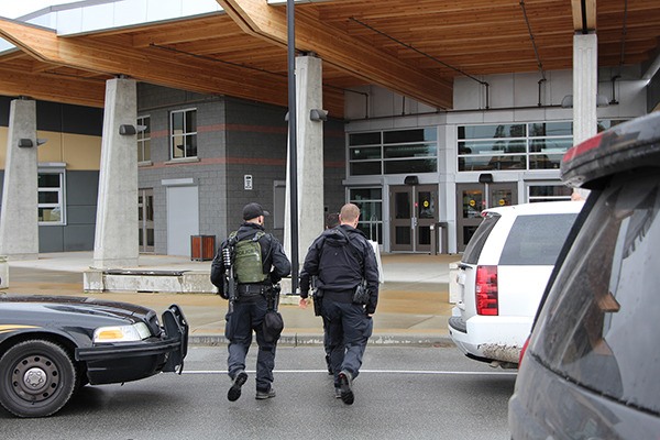 Members of the emergency response team enter Abbotsford Senior Secondary following a double stabbing.