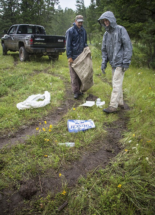 Volunteers pick up litter during a clean up effort at Lake Enid in early 2012