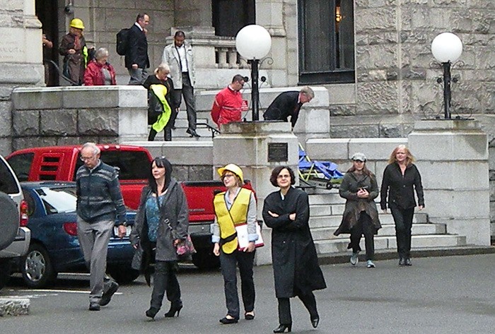 Staff evacuate the B.C. legislature Thursday in the Great B.C. ShakeOut