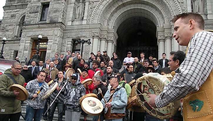 Paul Lacerte (right) joins a drum circle at the B.C. legislature Thursday to mark the fourth annual Gathering of Men to speak out against violence directed at aboriginal women and children.