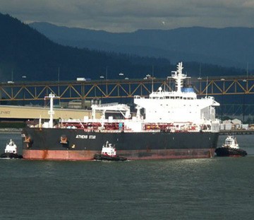 Oil tanker exits Second Narrows with Alberta crude from TransMountain pipeline terminal at Burnaby. An oil port for 100 years