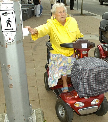 A mobility scooter user prepares to cross the street in White Rock. The vehicles are legal for sidewalks