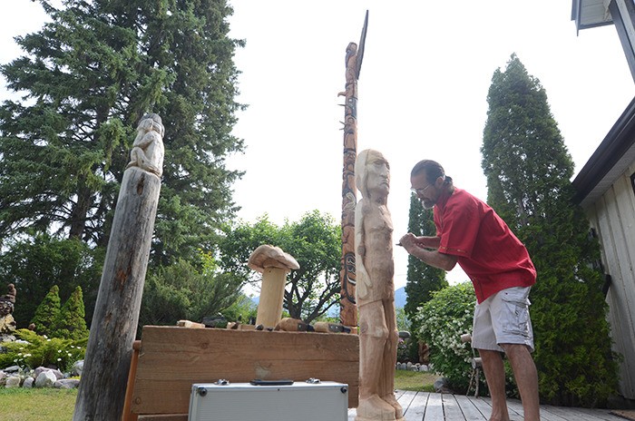 Jack Olson comes alive with his work at his outdoor carving paradise at the J. Olson Studio in Windermere on Thursday