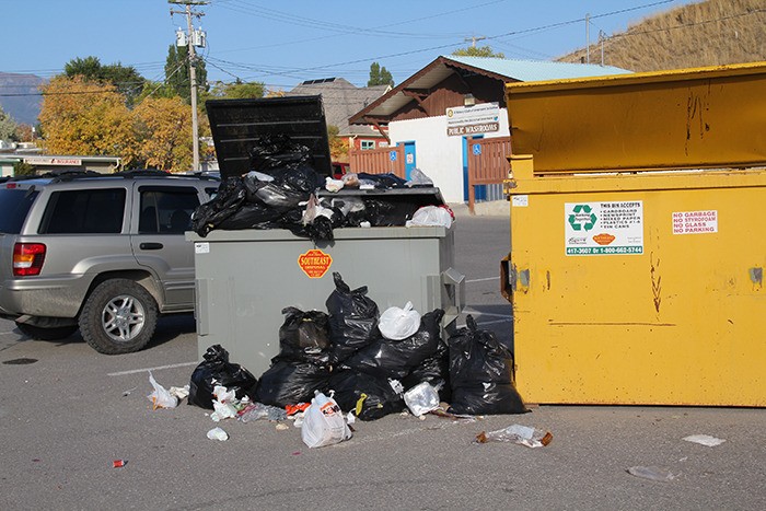 This dumpster in the village parking lot behind the Fields store has been overflowing with garbage for a few days