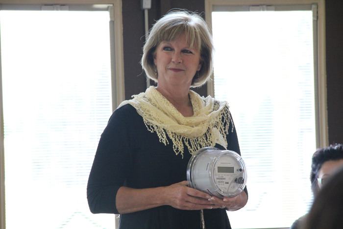 Village of Radium Hot Springs mayor Dee Conklin holds up the first smart meter to be installed in the Radium-Invermere area at the Women's Town Hall on July 31. The new metering system will measure hourly consumption rates