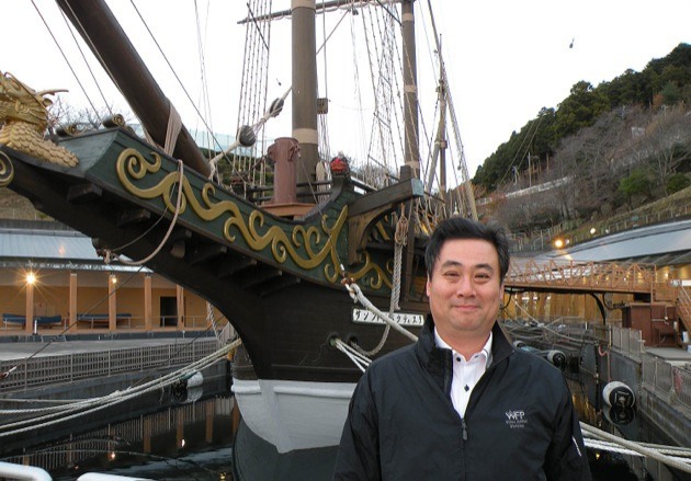 George Omori of Western Forest Products' Japan office stands before the reconstructed San Juan Bautista