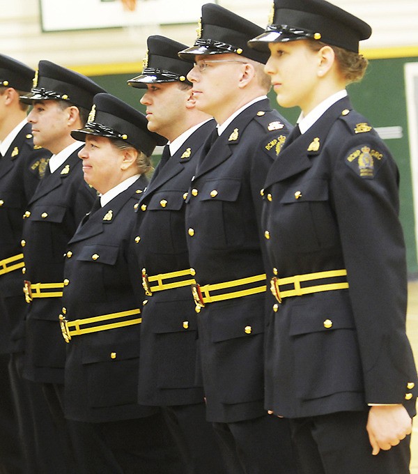 A class of auxiliary police officers graduate. New rules have been introduced for the volunteer officers.