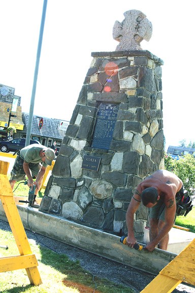 Workers sprucing up the Cenotaph Park monument.