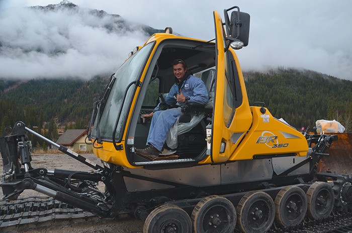 Resort mechanic Stephen McIntosh unloads the newest edition to Panorama’s high tech grooming fleet. Picture shows snowcat being prepared to get its tracks and blade installed.